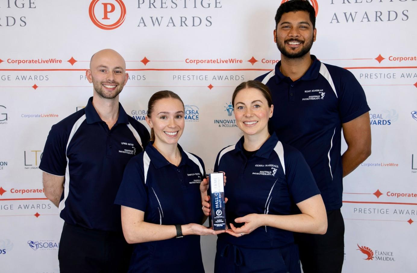 Lewis Rebecca Sujay and Gemma accepting best clinic award from Prestige Awards